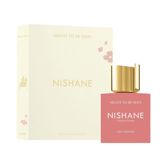 Nishane 'Meant to be Seen' Extrait de Parfum bottle and its matching cream-colored packaging box, featuring a gold cap and a pink bottle body.