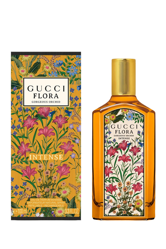Gucci Flora Intense perfume bottle and its matching outer packaging box, both decorated with a vibrant floral pattern on a yellow-gold background, set against a plain white background.