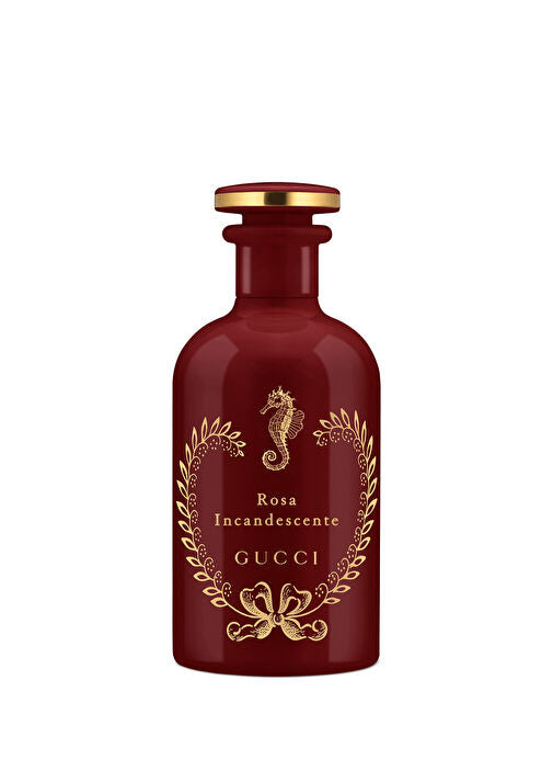 Gucci Rosa Incandescente perfume bottle in deep burgundy glass with gold foil detailing, a seahorse emblem, and a gold cap, shown on a plain white background.