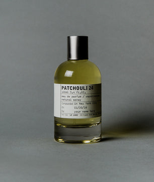 Perfume bottle labeled 'Patchouli 24' on a gray background