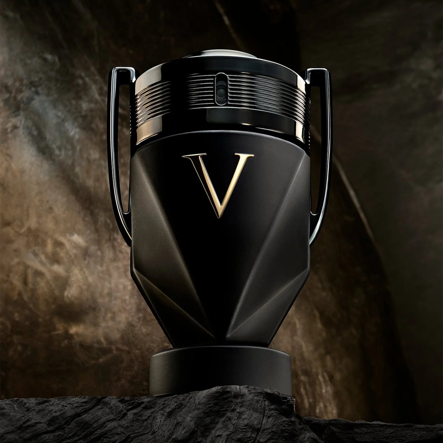 Black and gold product with a prominent 'V' logo on a textured dark background
