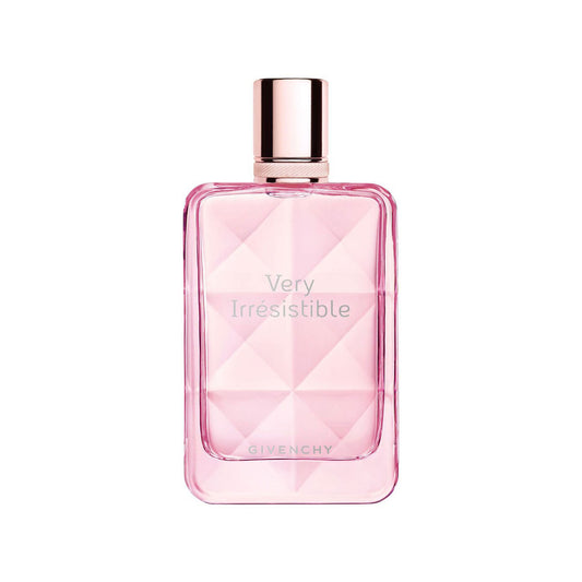A pink Givenchy Very Irresistible perfume bottle with a faceted geometric design and a metallic rose gold cap, centered on a plain white background.