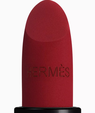 Red lipstick with black base and 'Hermès' branding on a white background