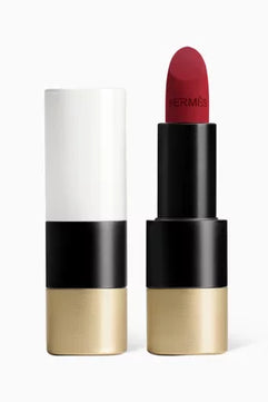 Lipstick with gold and black casing on a white background