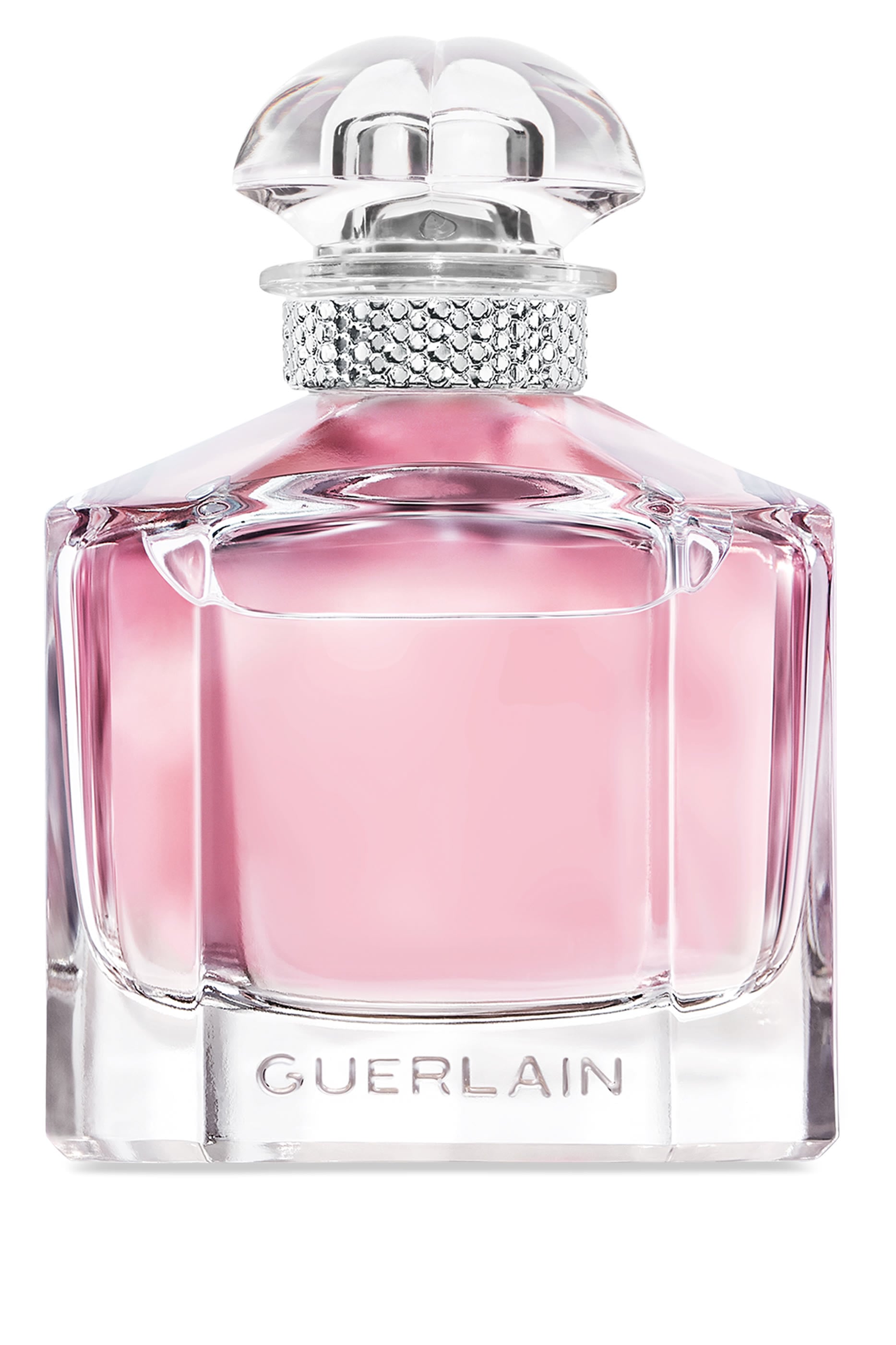 Guerlain perfume bottle with a faceted clear glass body filled with pink liquid, a silver rhinestone-embellished neck, and a clear sculptural cap on a white background.