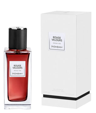 Red perfume bottle with black cap and white label next to its packaging box on a white background