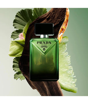 Green Prada perfume bottle with leaves on a light green background