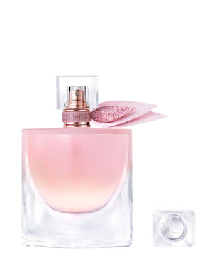 Pink and clear perfume bottle with cap on a white background