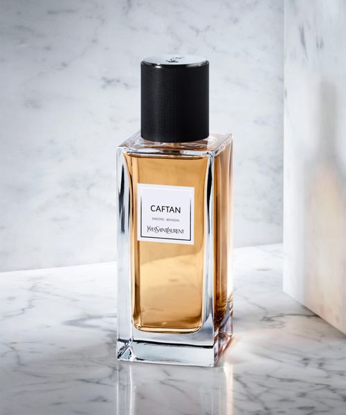 Perfume bottle labeled 'CAFTAN' on a marble surface