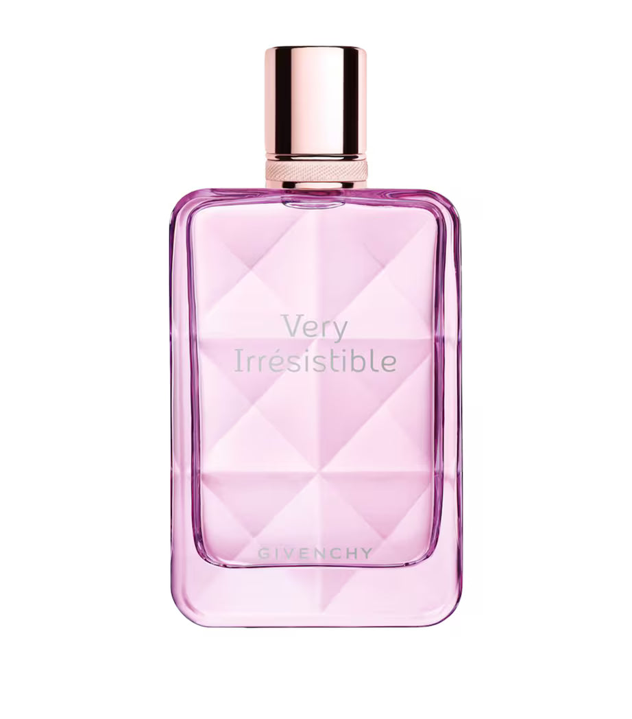 Pink Givenchy perfume bottle with rose gold cap on a white background
