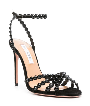 Black high-heeled sandal with bead detailing on a white background