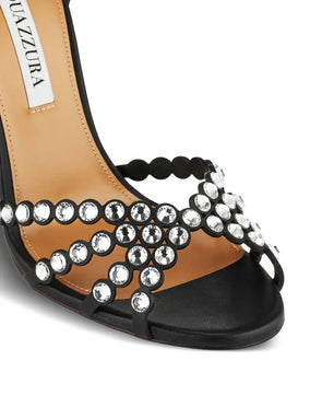 Black sandal with silver embellishments on a white background