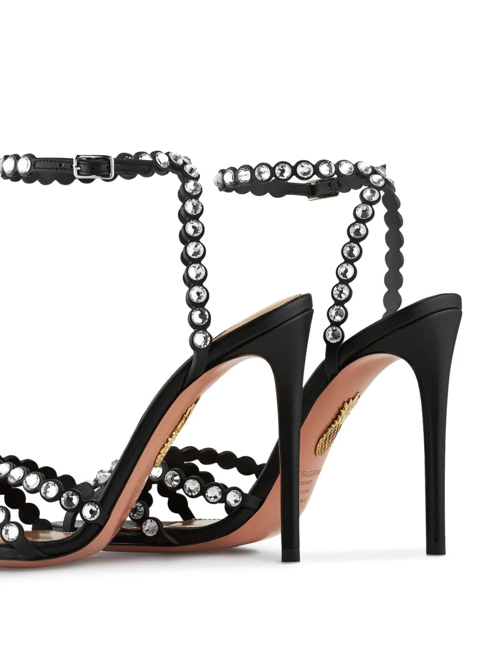 Black high-heeled sandals with beaded straps on a white background