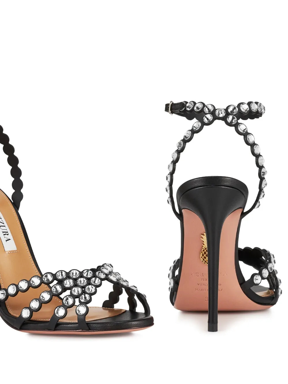 Black high-heeled sandals with beaded straps on a white background