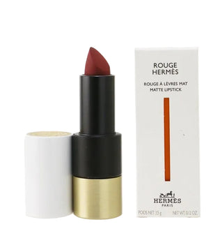 Hermes lipstick with black and gold casing and white box on a white background