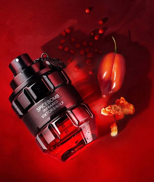 Viktor & Rolf Spicebomb Inferno perfume bottle on a red background with chili peppers.