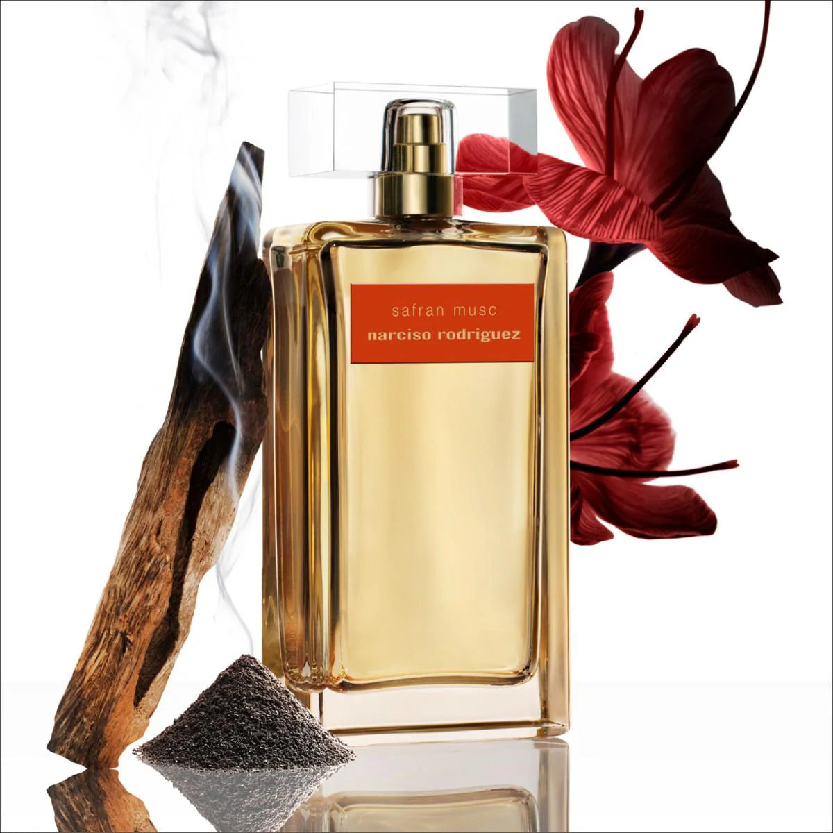 Narciso Rodriguez saffron musc perfume bottle with a red flower and wooden element on a white background