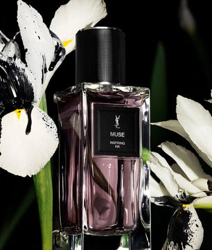 YSL Muse perfume bottle with white flowers in the background