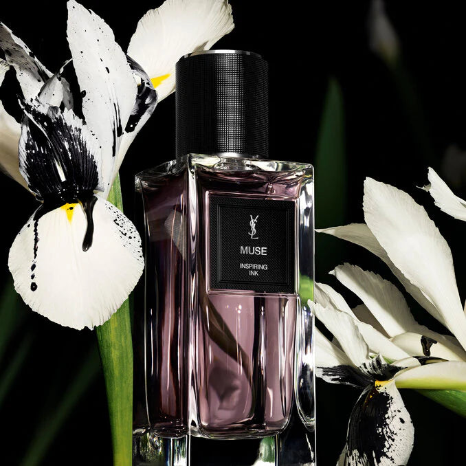 YSL Muse perfume bottle with white flowers in the background