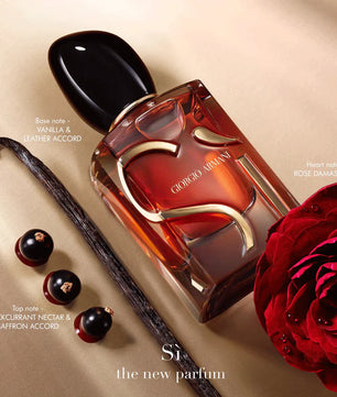 Giorgio Armani perfume bottle with a red rose and vanilla bean on a beige background