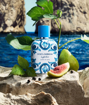 Dolce & Gabbana Light Blue perfume bottle with fig and leaves on a rocky surface