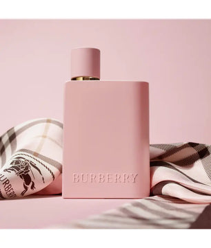 Pink Burberry perfume bottle on a pink background with a checkered cloth.