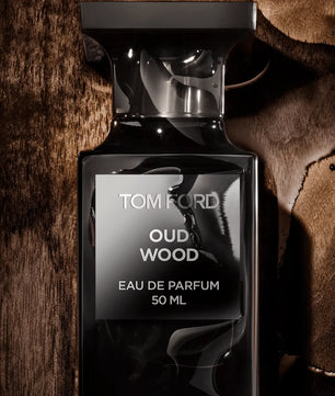 Tom Ford Oud Wood Eau de Parfum bottle on a textured brown background