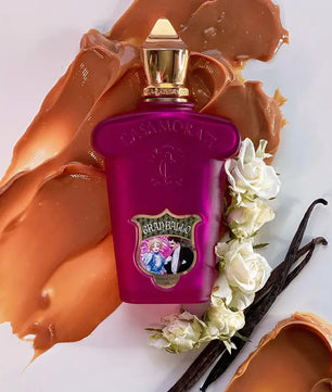 Purple perfume bottle with gold cap on a white background with floral and vanilla elements