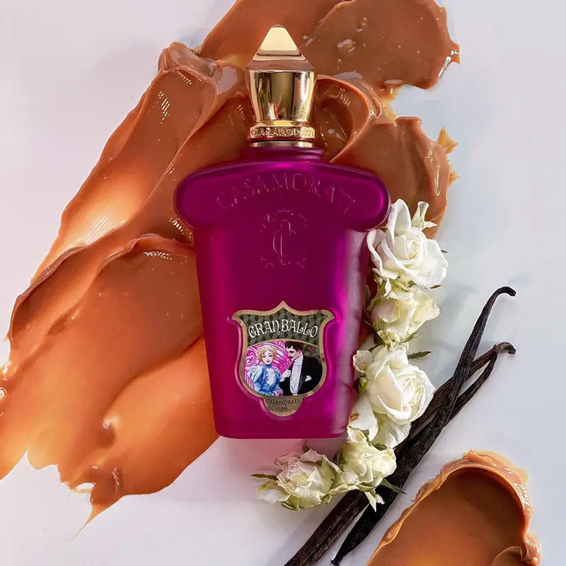 Purple perfume bottle with gold cap on a white background with floral and vanilla elements