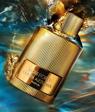 Gold Tom Ford Costa Azzurra parfum bottle with water droplets on a blue background