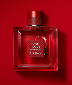 Red Guerlain perfume bottle on a red background