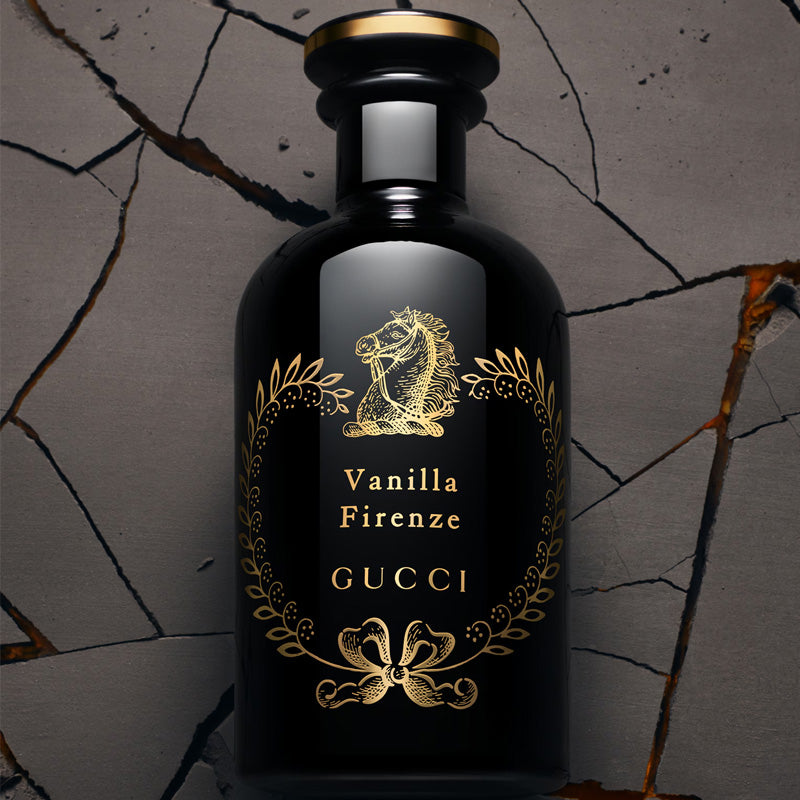 Gucci Vanilla Firenze perfume bottle on a textured gray background
