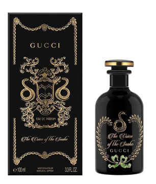 Gucci perfume bottle and packaging with decorative elements on a white background