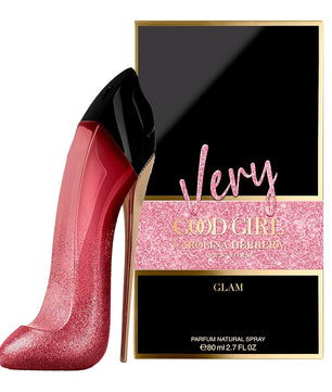 Pink high-heeled shoe and Carolina Herrera 'Very Good Girl Glam' perfume box on a white background