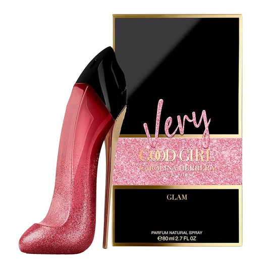 Pink high-heeled shoe and Carolina Herrera 'Very Good Girl Glam' perfume box on a white background
