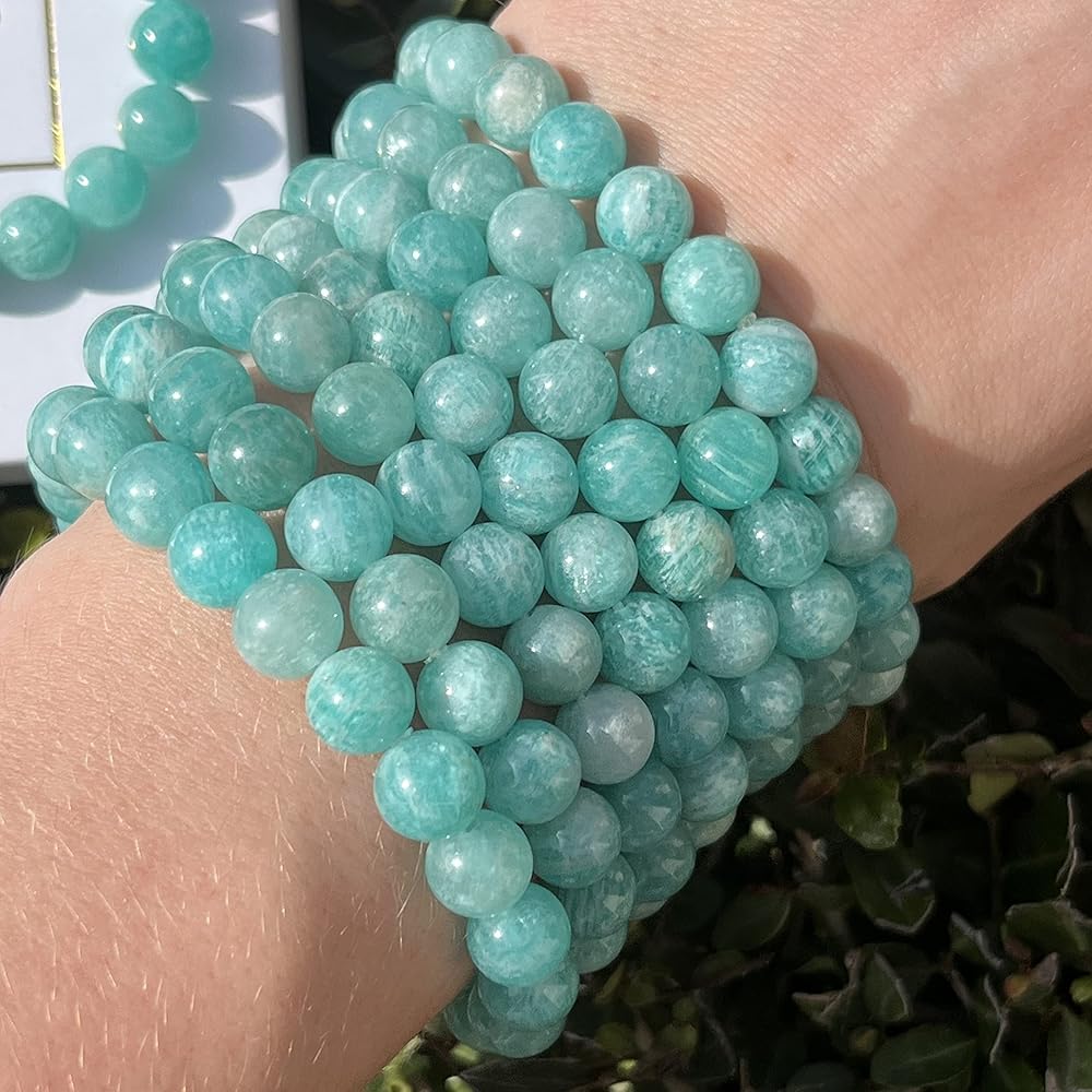 Turquoise beaded bracelet on a wrist with a blurred natural background