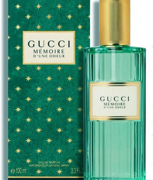 Gucci Memoire d'Une Odeur perfume bottle and packaging with gold accents on a white background