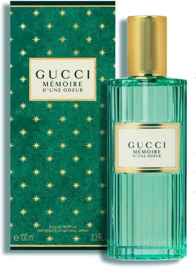 Gucci Memoire d'Une Odeur perfume bottle and packaging with gold accents on a white background