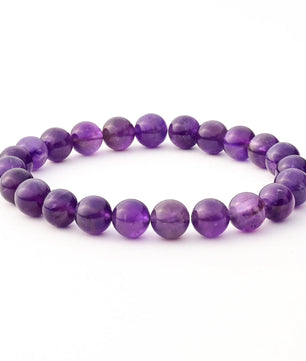 Purple beaded bracelet on a white background