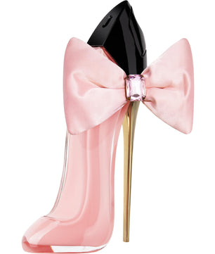 Pink high-heeled shoe-shaped perfume bottle with a large bow on a white background