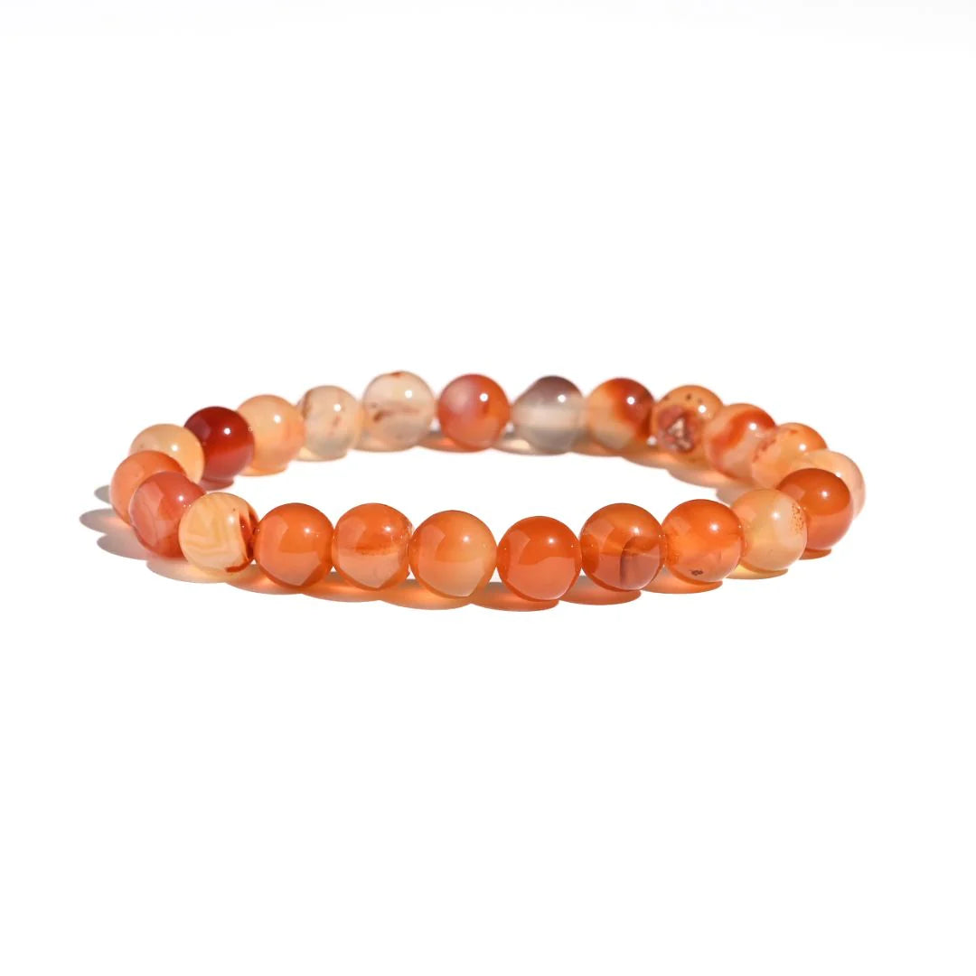 Beaded bracelet with orange and red beads on a white background