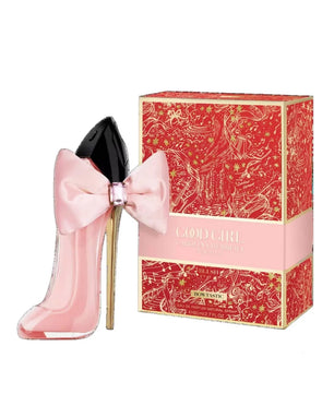 Pink high-heeled shoe with a bow next to its packaging on a white background