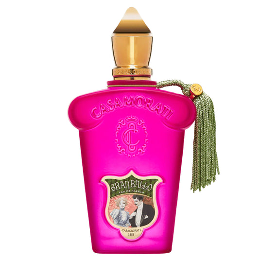 Pink Casamorati perfume bottle with gold cap and green tassel on a white background