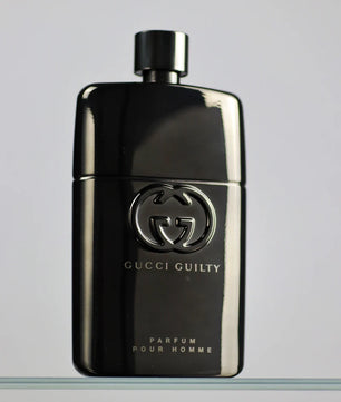 Gucci Guilty perfume bottle on a gray background