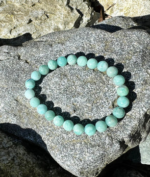 Turquoise beaded bracelet on a rock