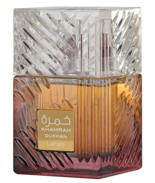 Perfume bottle with intricate design and 'Khamrah Dukhan' branding on a white background