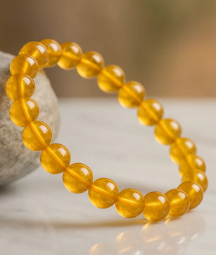 Yellow beaded bracelet on a neutral background