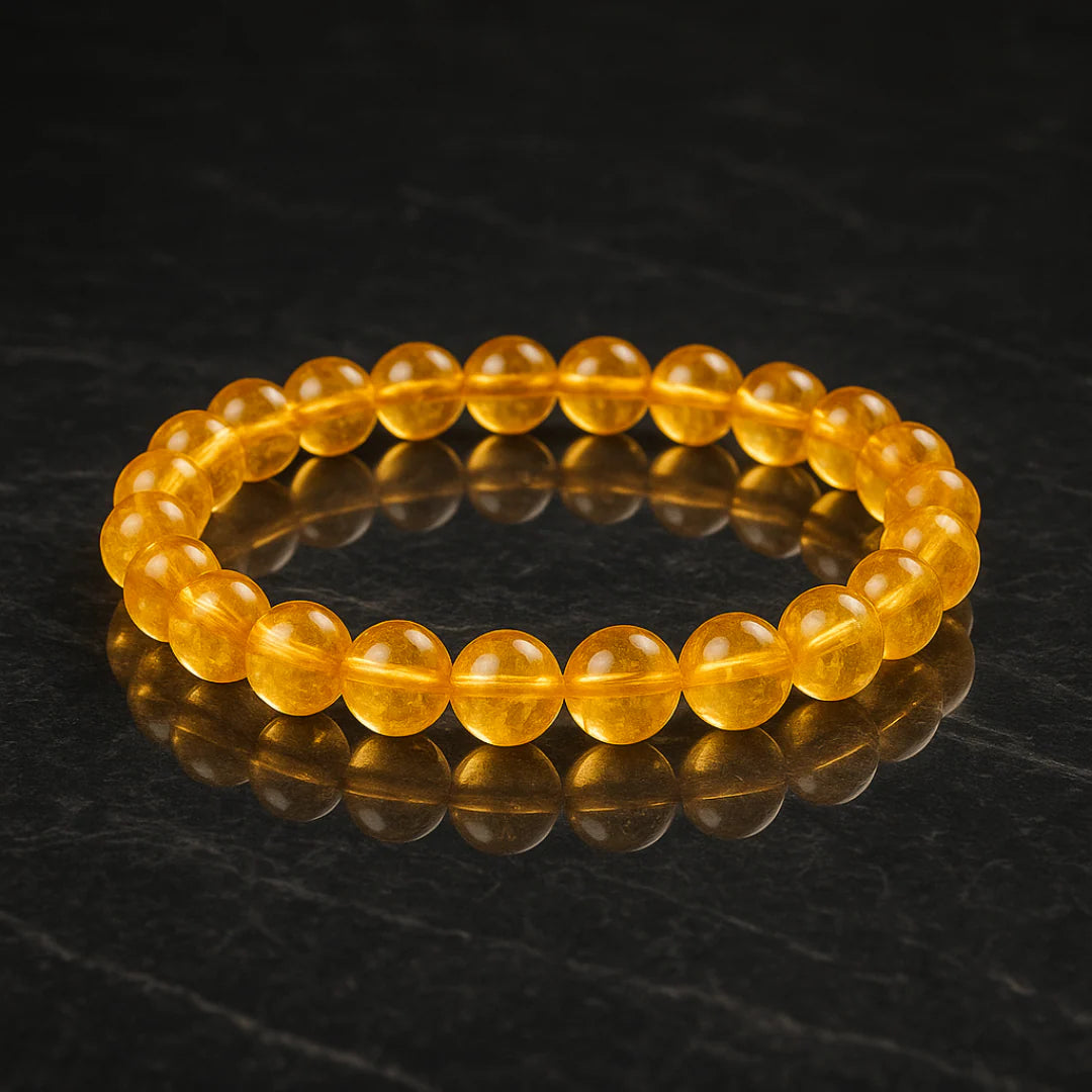 Yellow beaded bracelet on a dark reflective surface