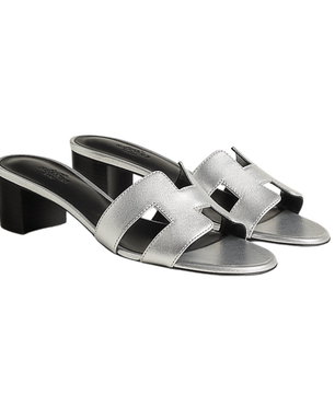 Silver sandals with a block heel on a white background