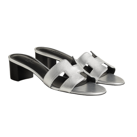 Silver sandals with a block heel on a white background